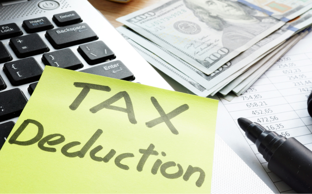 Tax deduction written on a memo stick
